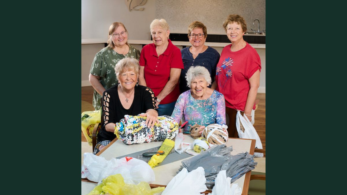 cedar-community-bag-ladies-volunteer-project Cedar Community residents working together to create sleeping mats from recycled plastic grocery bags.